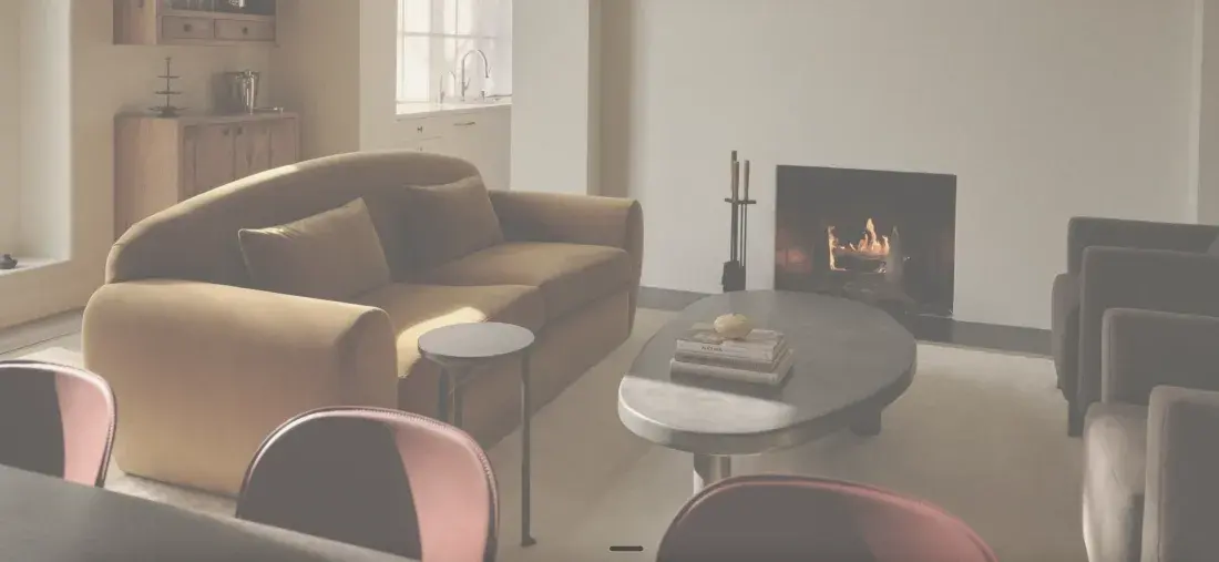 Lucie Project — sitting room with fireplace and camel sofa